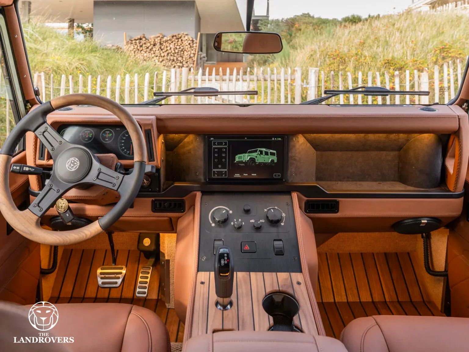 The working central touchscreen and physical controls in The Landrovers’ tan Panterra Rica dashboard.